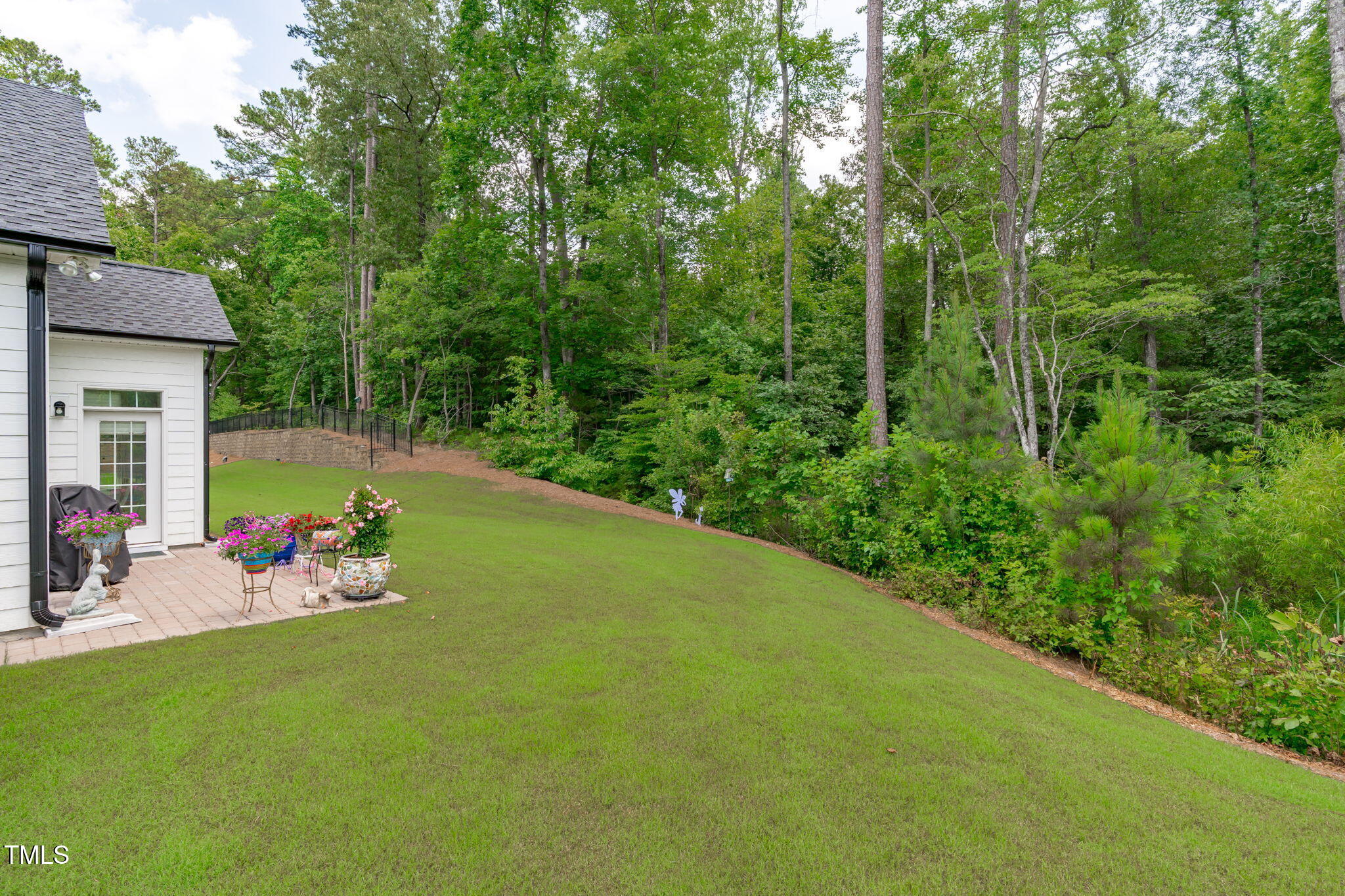 2511 Range Overlook Crossing Apex, NC 27523 - Photo 40 of 50 a view of a backyard with a garden and seating area