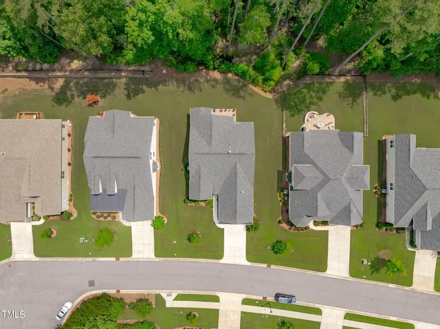 an aerial view of a house with a swimming pool