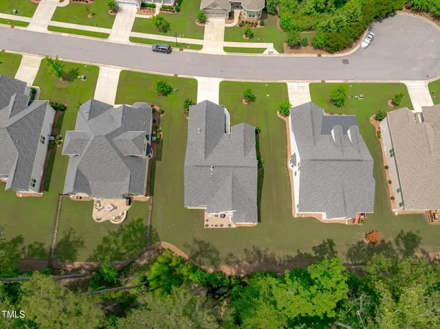 an aerial view of a house with a big yard