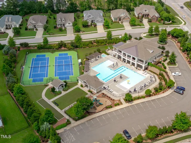 an aerial view of a house with a garden and parking