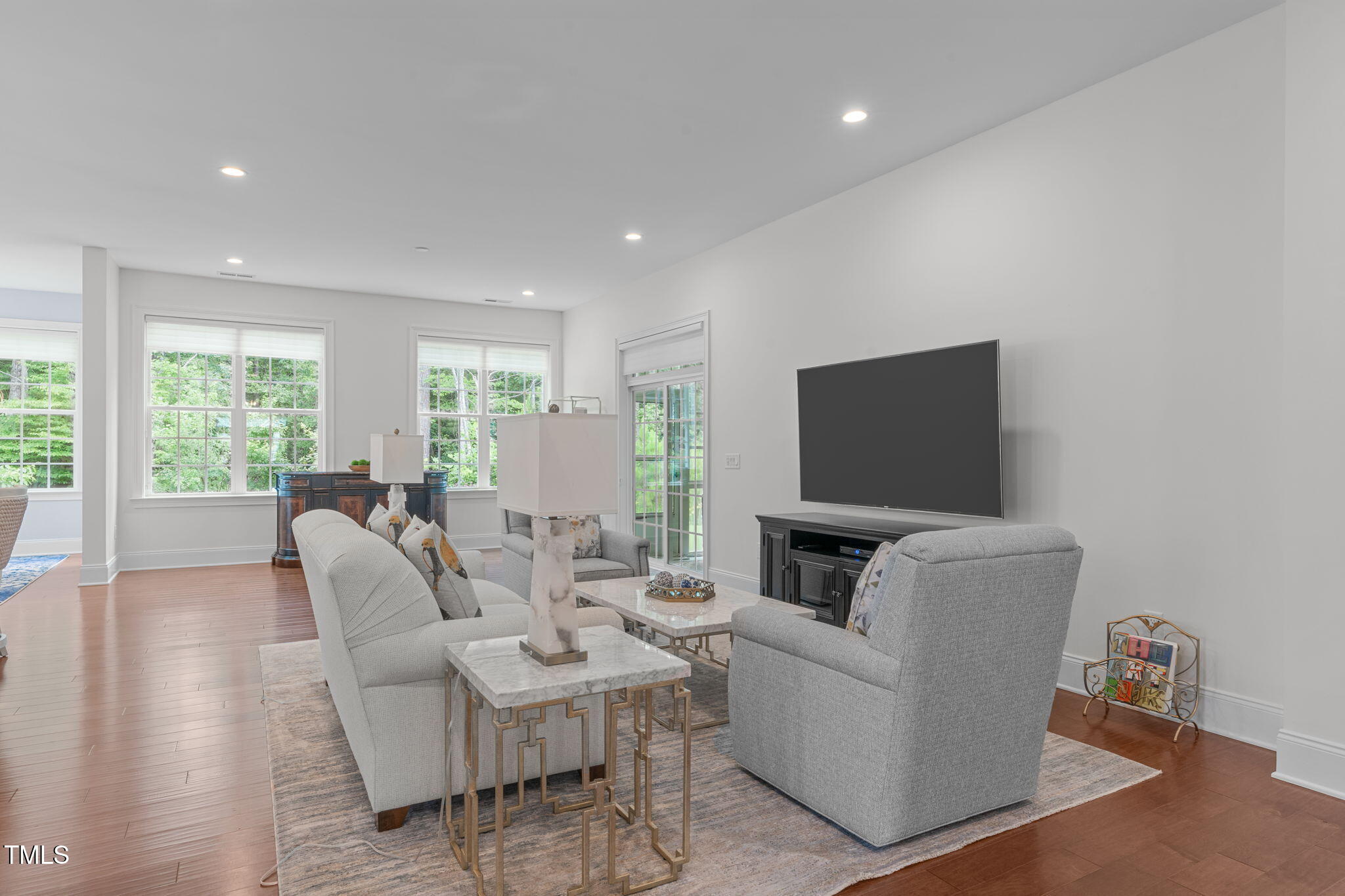2511 Range Overlook Crossing Apex, NC 27523 - Photo 6 of 50 a living room with furniture a flat screen tv and a fireplace