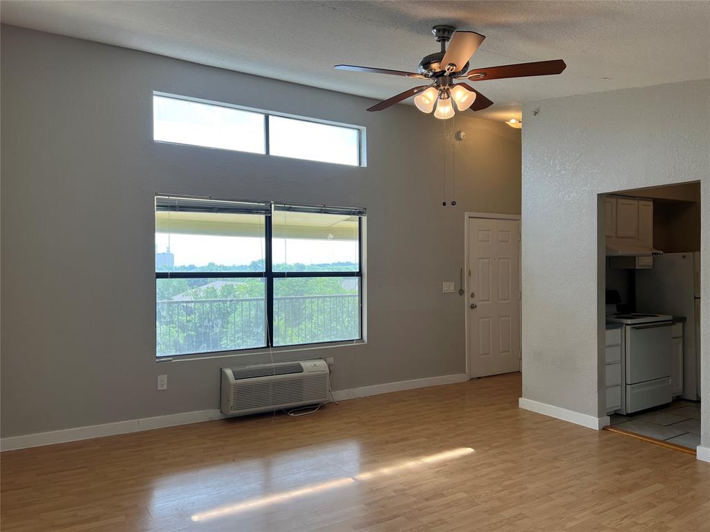 701 West Sycamore Street, Unit 303 Denton, TX 76201 - Photo 1 of 12 Naturally well lit living room featuring a stunning 3rd story view of downtown denton.