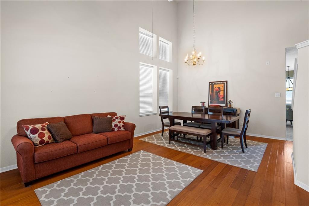 3508 Bratton Ridge Crossing Austin, TX 78728 - Photo 8 of 18 Hardwood floors and soaring ceilings define this inviting living and dining space.