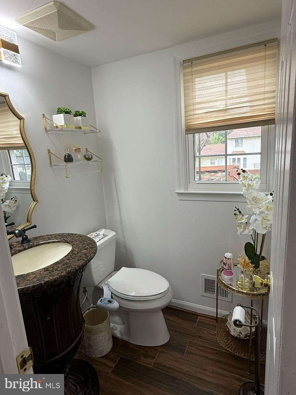 4082 Braxton Road Chantilly, VA 20151 - Photo 17 of 40 a bathroom with a granite countertop toilet a sink and a mirror