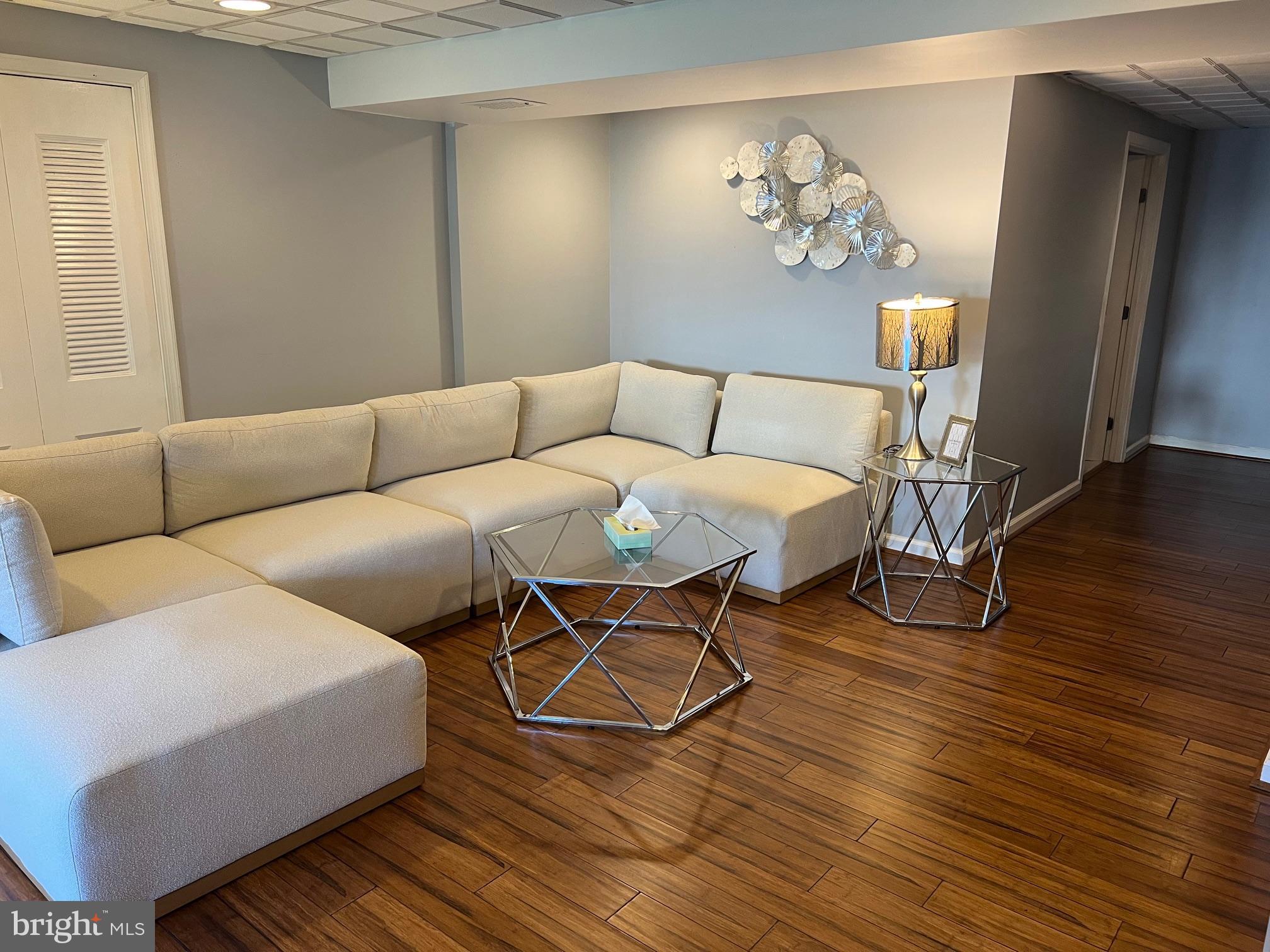 4082 Braxton Road Chantilly, VA 20151 - Photo 33 of 40 a living room with furniture a table and wooden floor