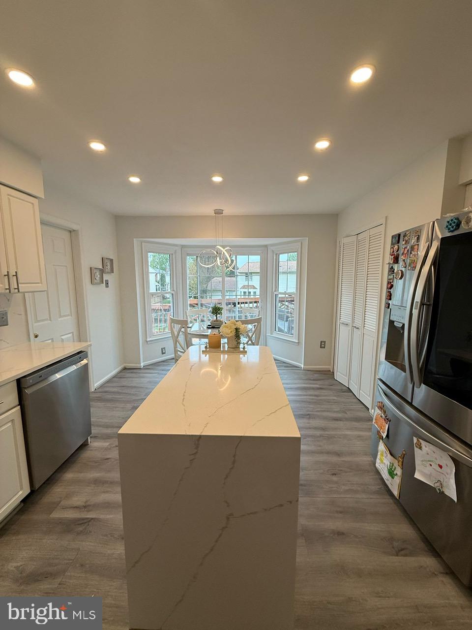 4082 Braxton Road Chantilly, VA 20151 - Photo 5 of 40 a large kitchen with kitchen island a sink dishwasher a stove and a refrigerator with wooden floor