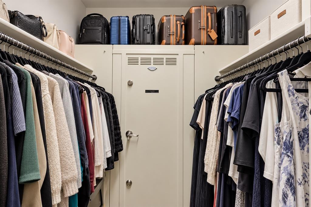 5112 Holy Springs Road Denton, TX 76207 - Photo 15 of 24 Oversized primary walk-in closet featuring a discreet Closet Centurion steel shelter and bullet-resistant safe room, seamlessly integrated into the space for added security and peace of mind while remaining unobtrusive in everyday use.