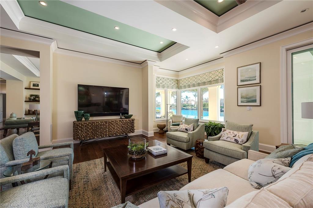 3450 Rum Row Naples, FL 34102 - Photo 12 of 25 a living room with furniture and a flat screen tv