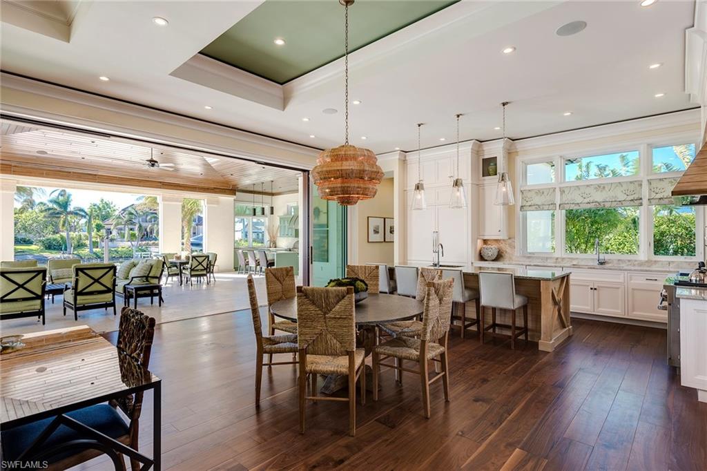 3450 Rum Row Naples, FL 34102 - Photo 14 of 25 a view of a dining room with furniture window and wooden floor