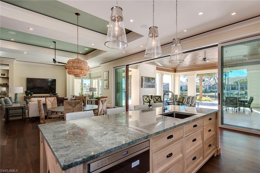 3450 Rum Row Naples, FL 34102 - Photo 16 of 25 a kitchen with stainless steel appliances granite countertop a sink and a large window