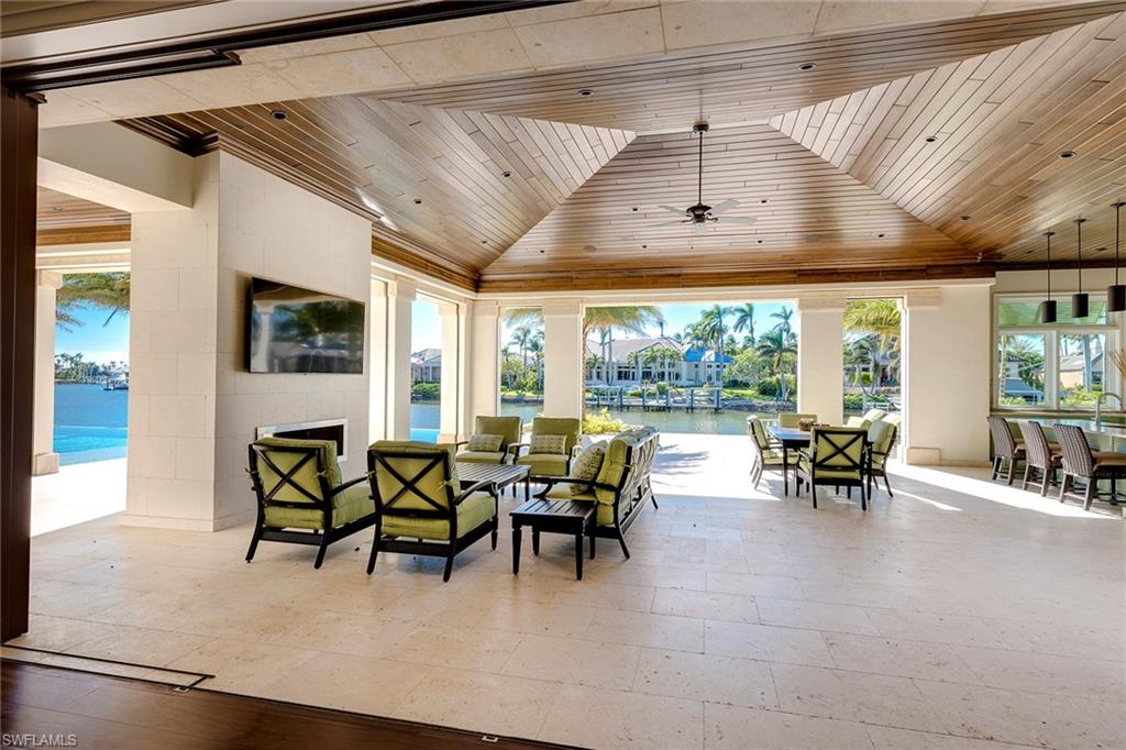 3450 Rum Row Naples, FL 34102 - Photo 17 of 25 a view of a dining room with furniture large windows and wooden floor