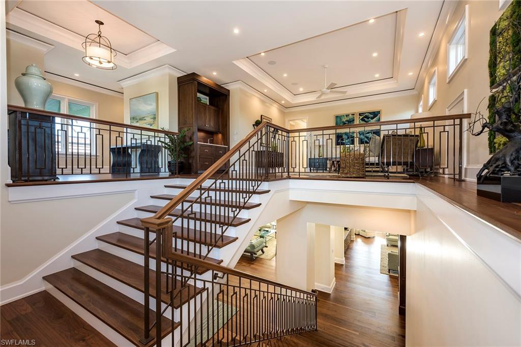 3450 Rum Row Naples, FL 34102 - Photo 23 of 25 a view of entryway and hall with wooden floor