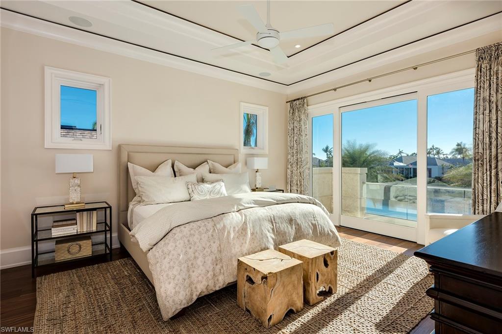 3450 Rum Row Naples, FL 34102 - Photo 24 of 25 a bedroom with a bed and a night stand