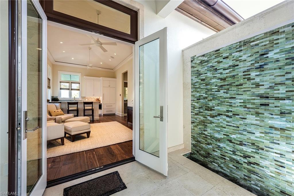 3450 Rum Row Naples, FL 34102 - Photo 25 of 25 a bedroom with a bed and a view of living room