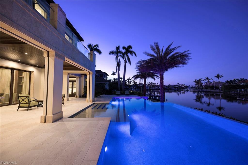 3450 Rum Row Naples, FL 34102 - Photo 5 of 25 a view of a swimming pool with chairs