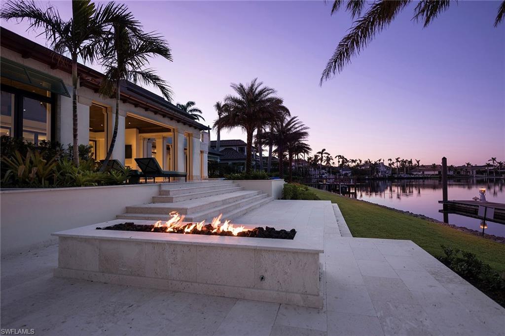 3450 Rum Row Naples, FL 34102 - Photo 7 of 25 a view of a house with yard and a garden
