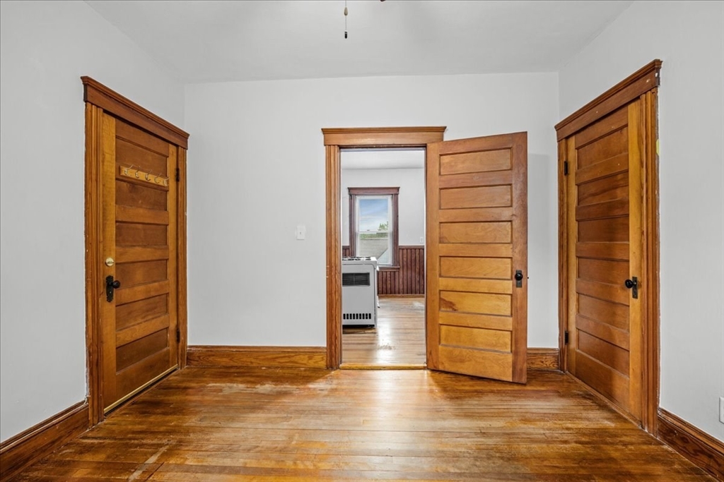 29 Tatman Street Worcester, MA 01607 - Photo 12 of 42 an empty room with wooden door and closet