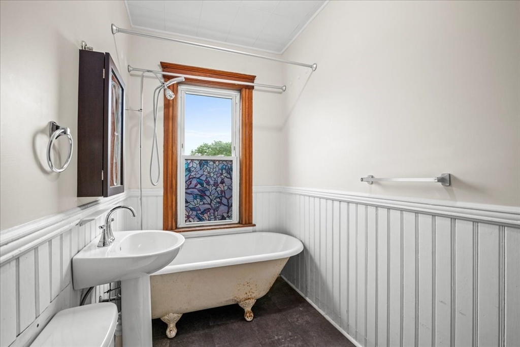 29 Tatman Street Worcester, MA 01607 - Photo 15 of 42 a bathroom with a sink a mirror and a bathtub