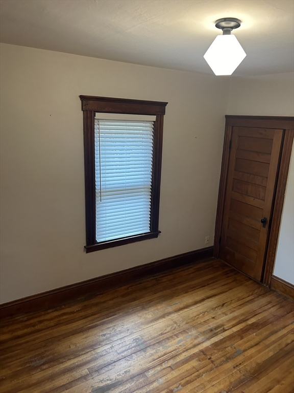 29 Tatman Street Worcester, MA 01607 - Photo 26 of 42 a view of an empty room with wooden floor and a window