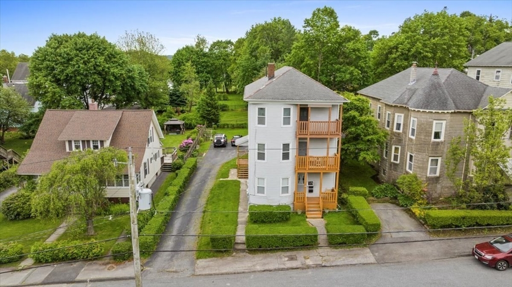 29 Tatman Street Worcester, MA 01607 - Photo 41 of 42 a front view of a house with a yard and potted plants