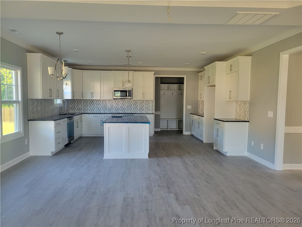 2960 H Clark Road Fayetteville, NC 28306 - Photo 4 of 33 a kitchen with granite countertop a refrigerator and a stove top oven