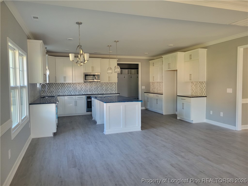 2960 H Clark Road Fayetteville, NC 28306 - Photo 5 of 33 a open kitchen with white cabinets and stainless steel appliances