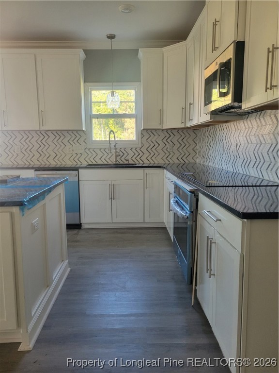 2960 H Clark Road Fayetteville, NC 28306 - Photo 7 of 33 a kitchen with stainless steel appliances granite countertop a stove a sink and a microwave