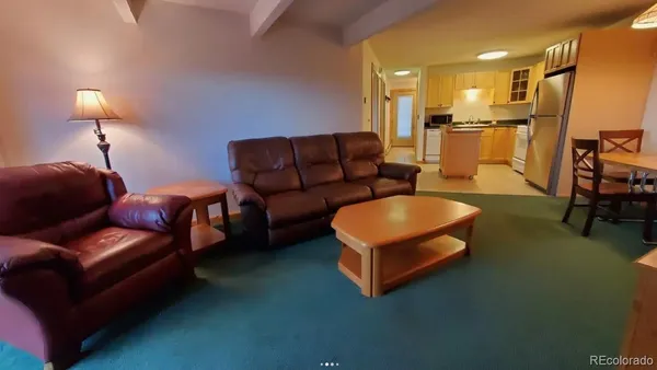 a living room with furniture and a lamp