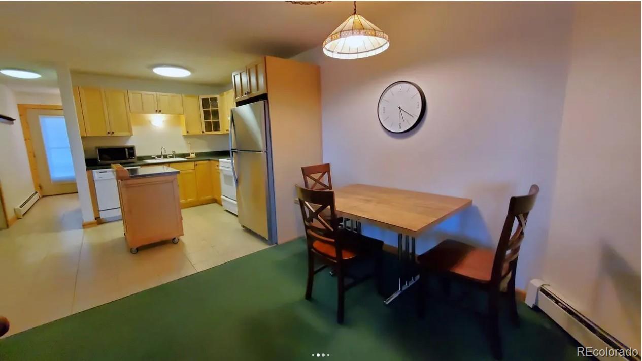 7223 Ryan Gulch Road Silverthorne, CO 80498 - Photo 3 of 20 a view of a dining room with furniture window and wooden floor