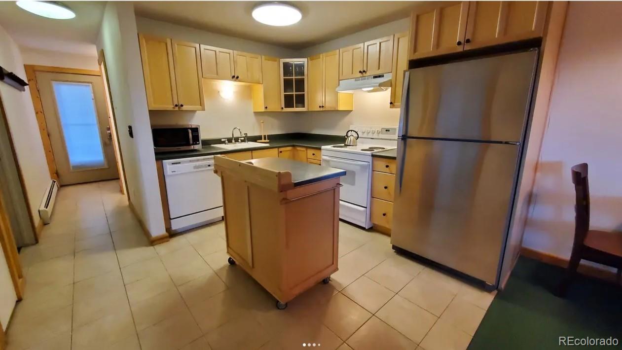 7223 Ryan Gulch Road Silverthorne, CO 80498 - Photo 4 of 20 a kitchen with stainless steel appliances granite countertop a refrigerator a stove a sink and a refrigerator