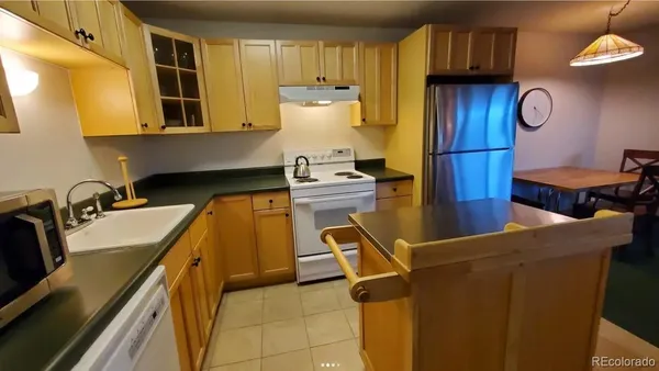 a kitchen with a refrigerator and a stove