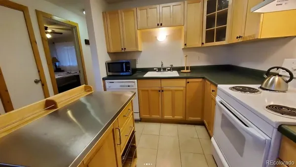 a kitchen with a sink a stove and cabinets