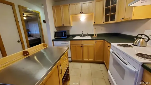 a kitchen with a sink a stove and cabinets