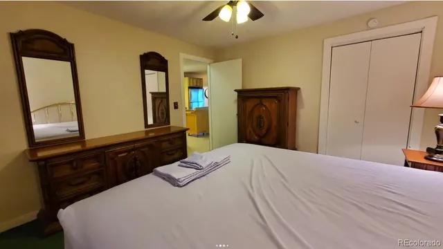 a bedroom with double bed and a dresser
