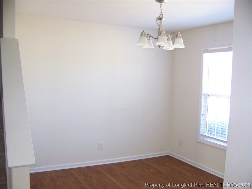 92 Cobblestone Drive Spring Lake, NC 28390 - Photo 12 of 24 an empty room with chandelier fan and windows