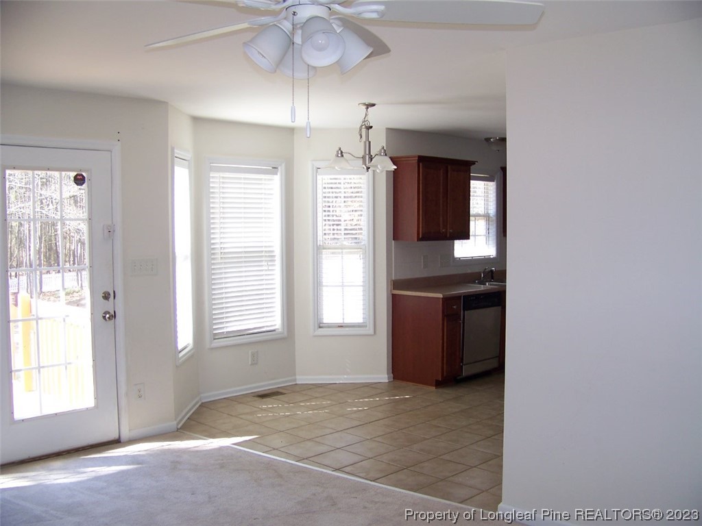 92 Cobblestone Drive Spring Lake, NC 28390 - Photo 6 of 24 an empty room with chandelier and windows
