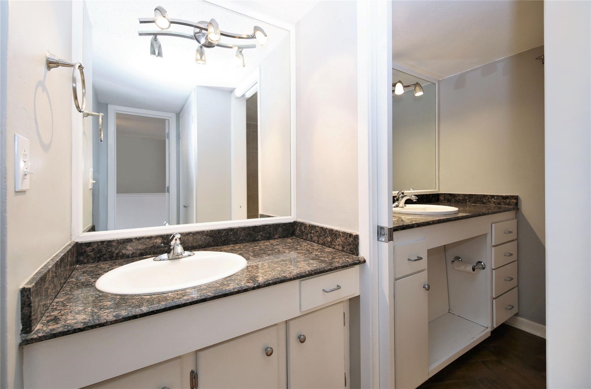 6433 Bayou Glen Road, Unit 6433 Houston, TX 77057 - Photo 15 of 19 a bathroom with a granite countertop sink and a mirror