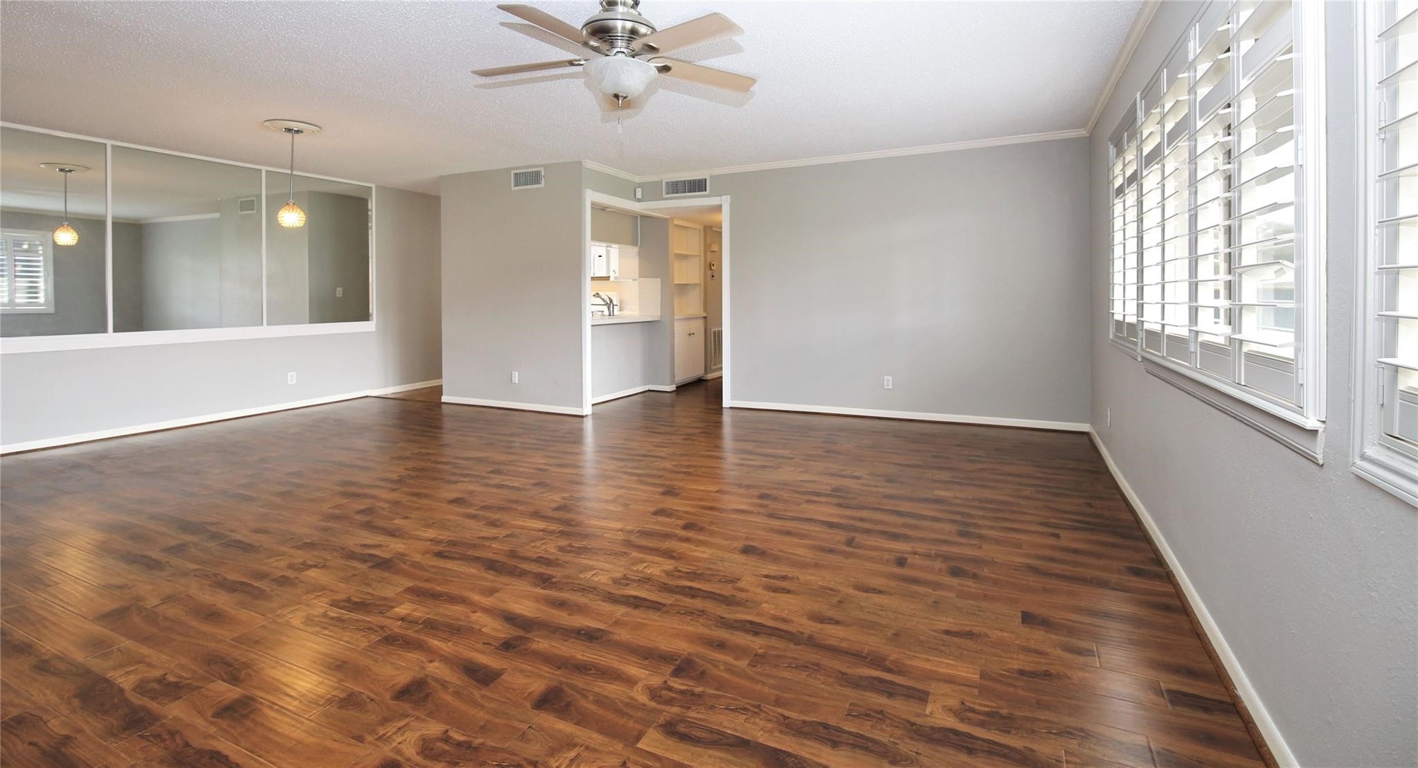 6433 Bayou Glen Road, Unit 6433 Houston, TX 77057 - Photo 2 of 19 wooden floor in an empty room with a window