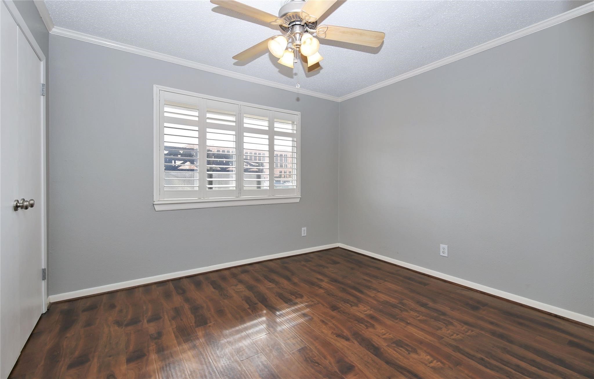 6433 Bayou Glen Road, Unit 6433 Houston, TX 77057 - Photo 8 of 19 a view of an empty room with window and wooden floor