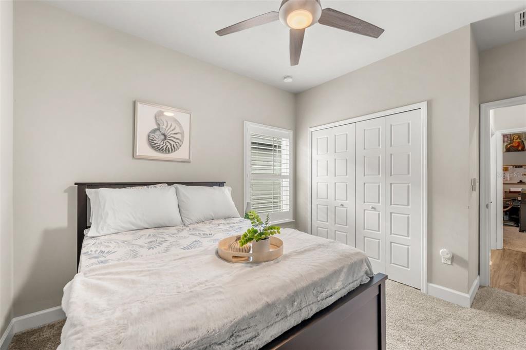 9437 Southwest 67th Lane Gainesville, FL 32608 - Photo 16 of 41 a bedroom with a bed and a chandelier