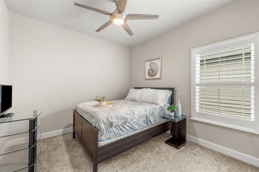 9437 Southwest 67th Lane Gainesville, FL 32608 - Photo 17 of 41 a bed sitting in a bedroom next to a window