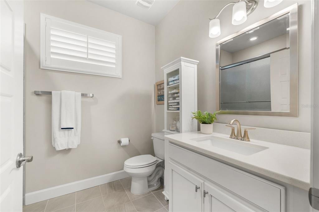 9437 Southwest 67th Lane Gainesville, FL 32608 - Photo 18 of 41 a bathroom with a sink a toilet and a mirror