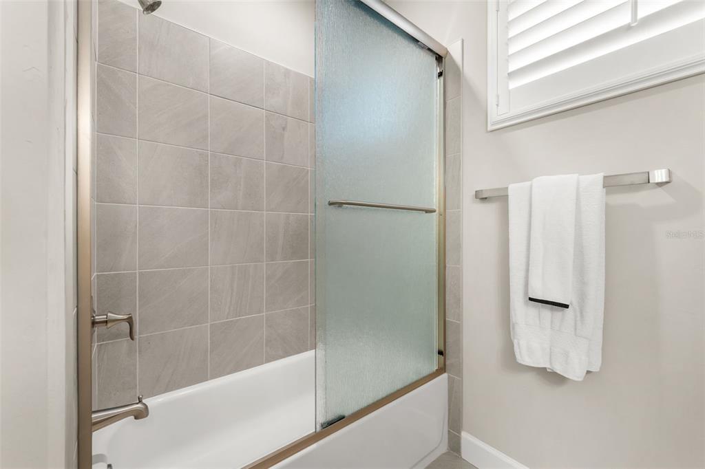 9437 Southwest 67th Lane Gainesville, FL 32608 - Photo 19 of 41 a bathroom with a bathtub and a shower