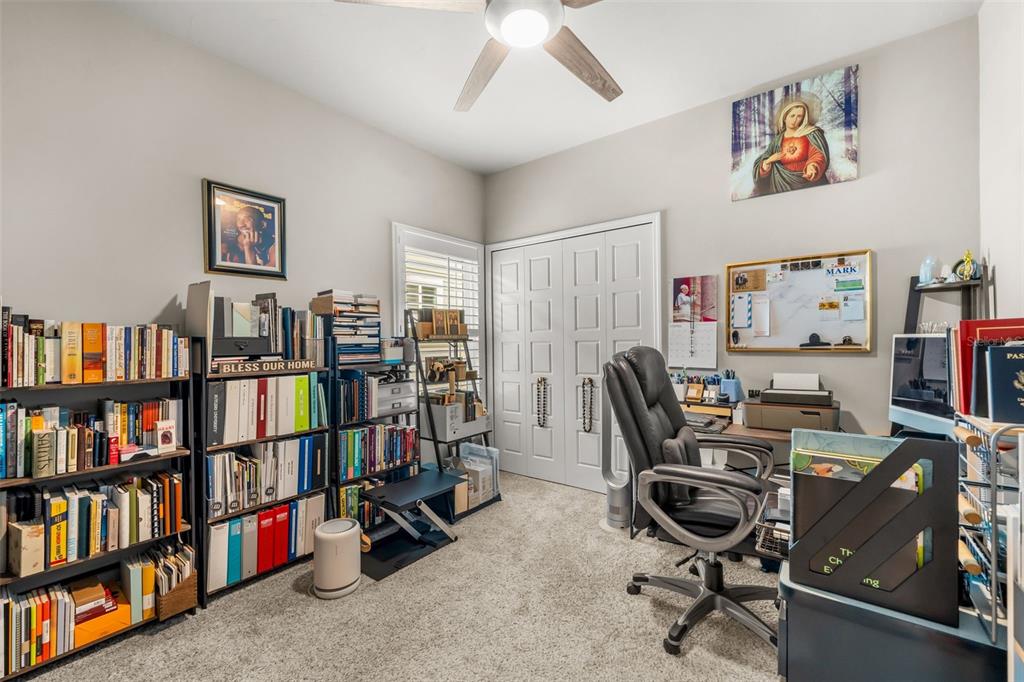 9437 Southwest 67th Lane Gainesville, FL 32608 - Photo 20 of 41 a view of a workspace with bookshelf and a workspace