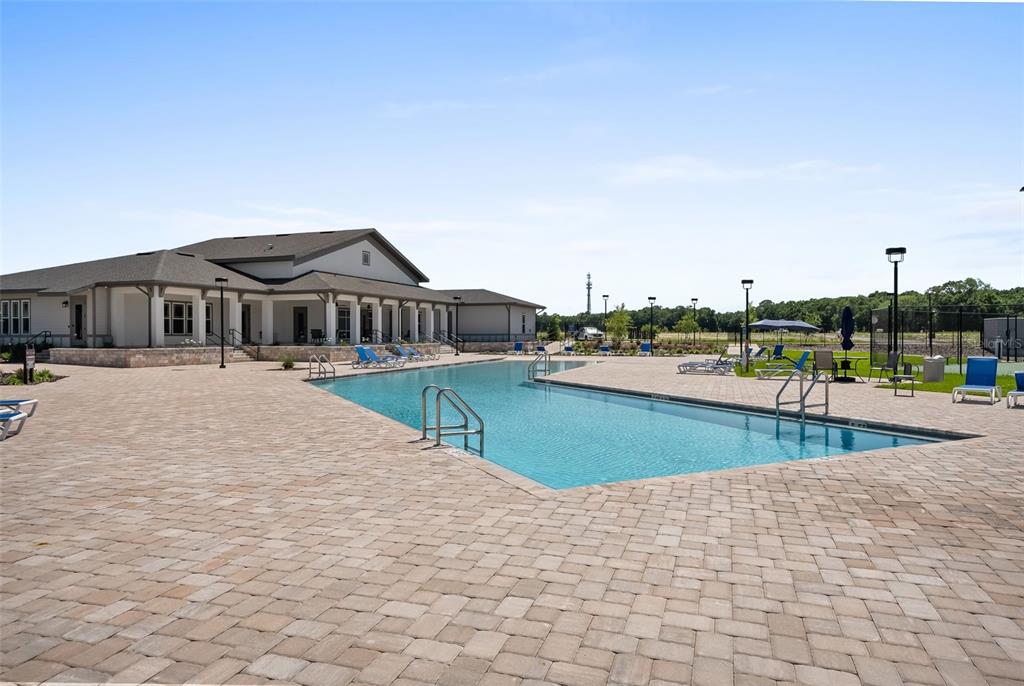 9437 Southwest 67th Lane Gainesville, FL 32608 - Photo 35 of 41 a view of swimming pool with outdoor seating and house in the background