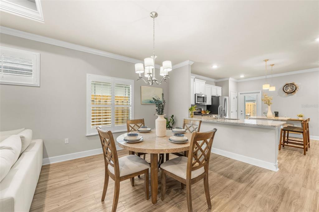 9437 Southwest 67th Lane Gainesville, FL 32608 - Photo 6 of 41 a view of a dining room with furniture window and wooden floor