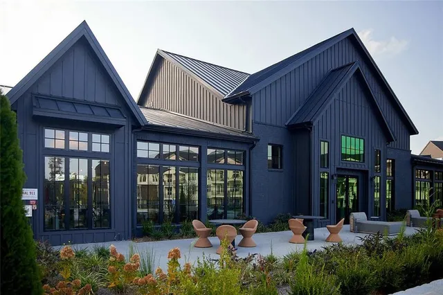 a view of a house with sitting area and garden