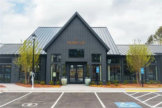 a front view of a building with a garden