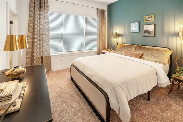 a spacious bedroom with a bed and a window