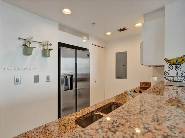 a bedroom with bed and cabinets